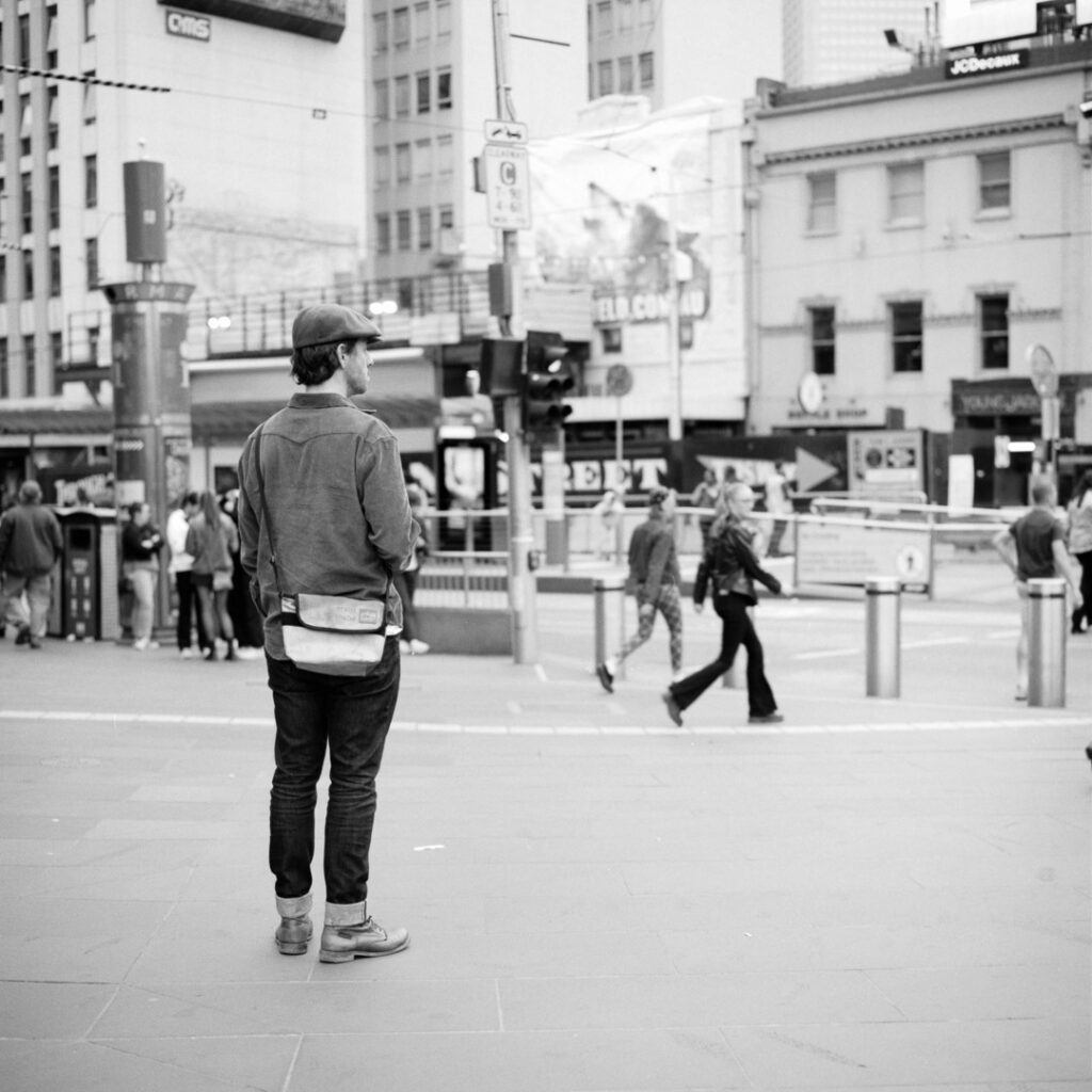 ilford fp4 black and white film photograph of man at Flinders st station, melbourne