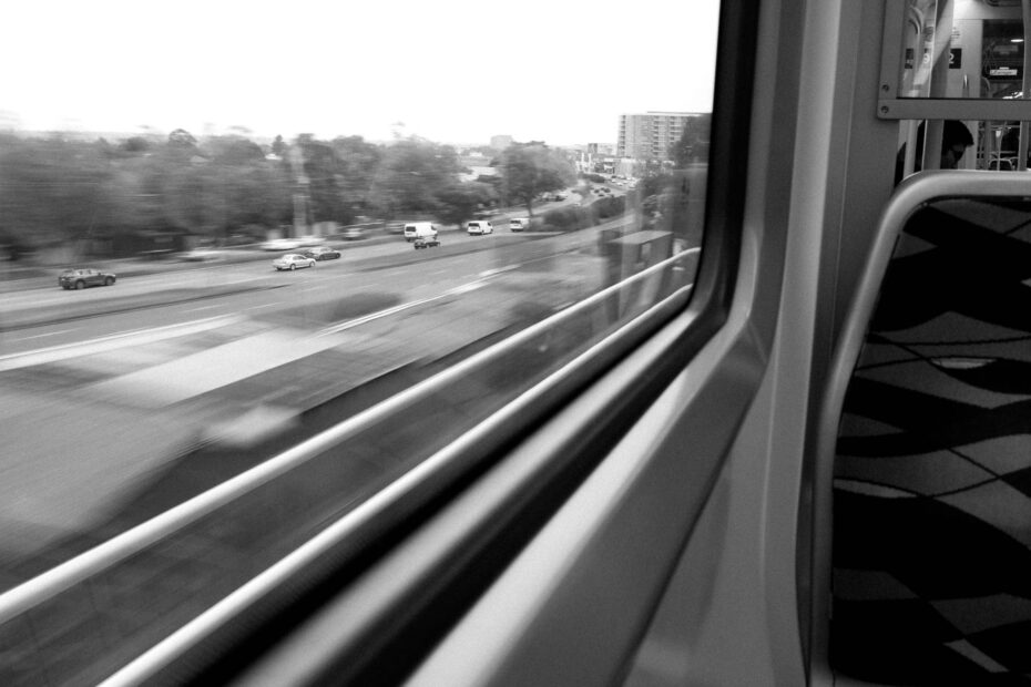 black and white photo of moving traffic taken from a train above the road. Spending time with photography is important to see the intricate details