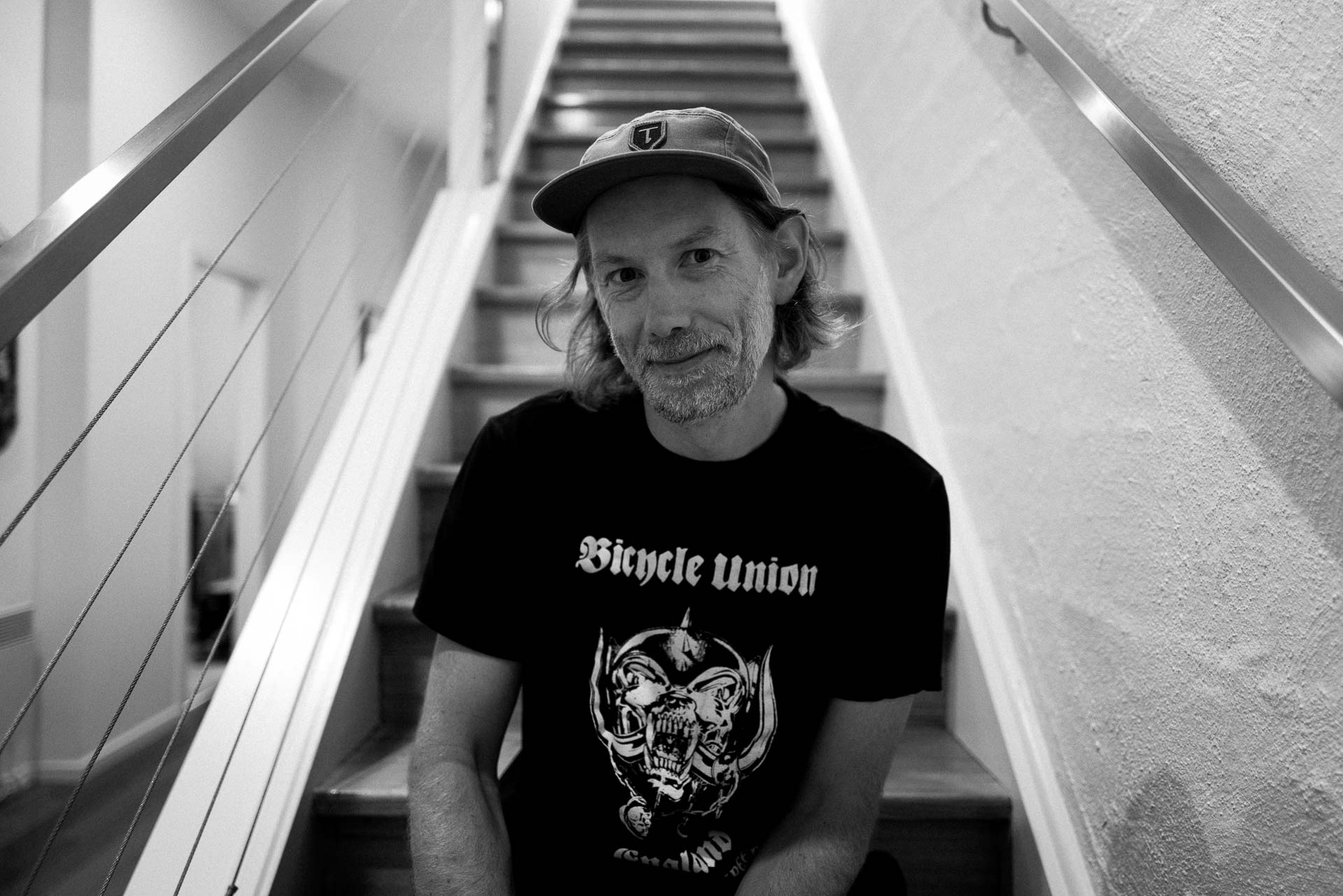 black and white portrait of a man on the stairs in his Brunswick apartment. why I stopped taking portraits