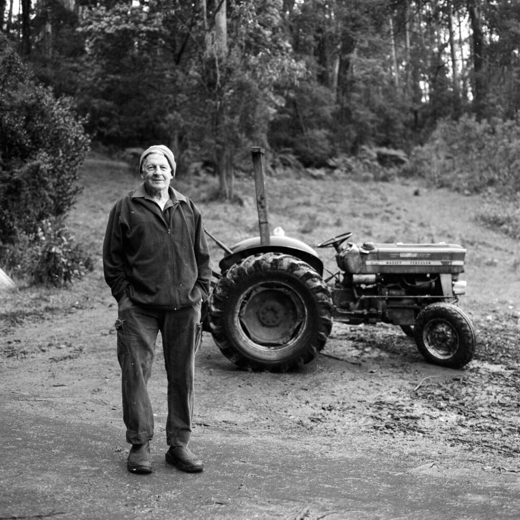black and white film portrait of a man and his tractor